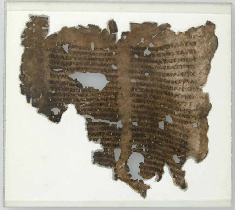A worn medieval manuscript fragment with dark lines of handwritten text