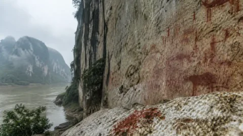 Red rock paintings on the limestone cliffs of Huashan in southern China
