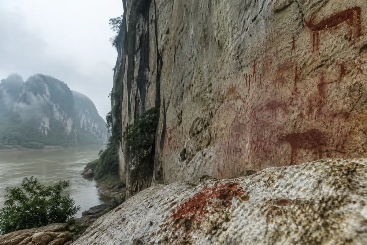 Red rock paintings on the limestone cliffs of Huashan in southern China
