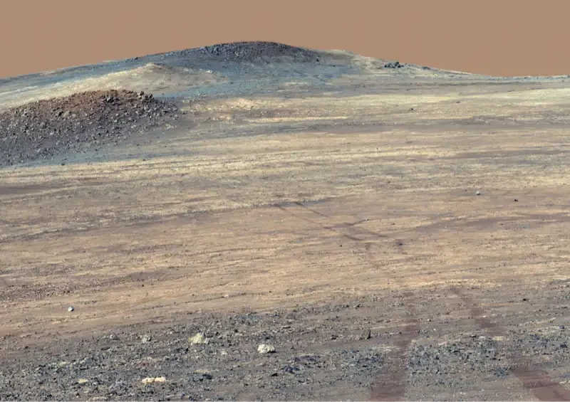 Wide Perseverance rover panorama of pale rocks and tracks at Broom Point on Mars