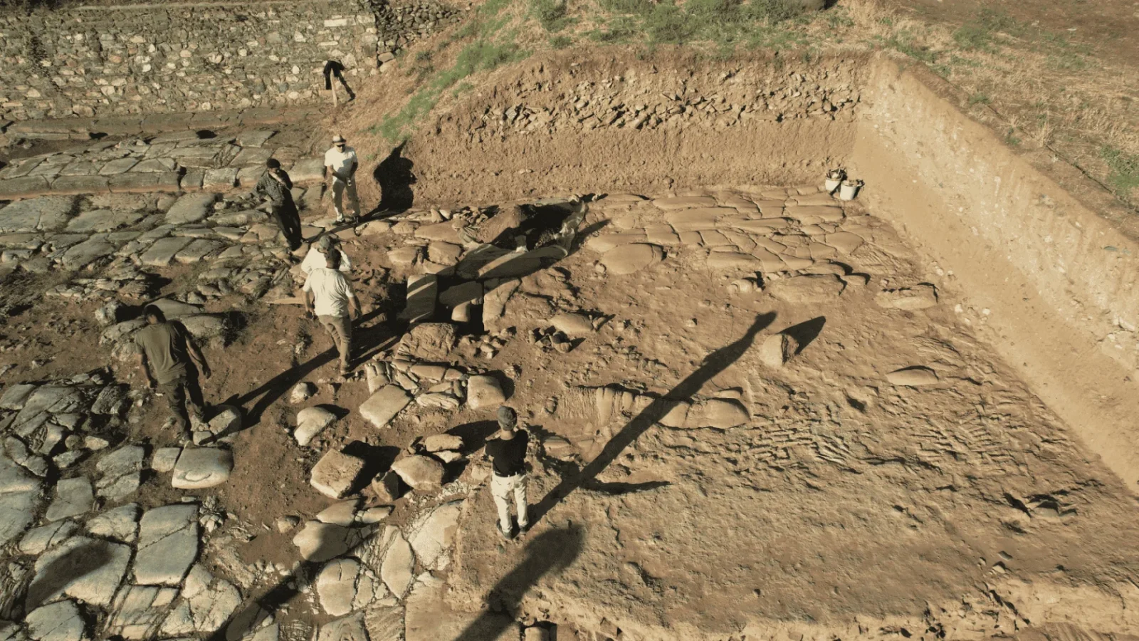 Archaeologists lifting fragments of a large stone statue at the Sardis excavation