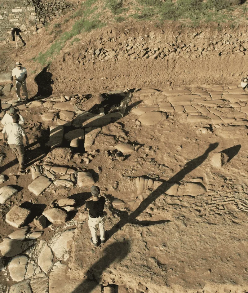Archaeologists lifting fragments of a large stone statue at the Sardis excavation