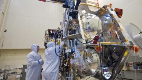 NASA engineers work on the electronics of a deep-space spacecraft