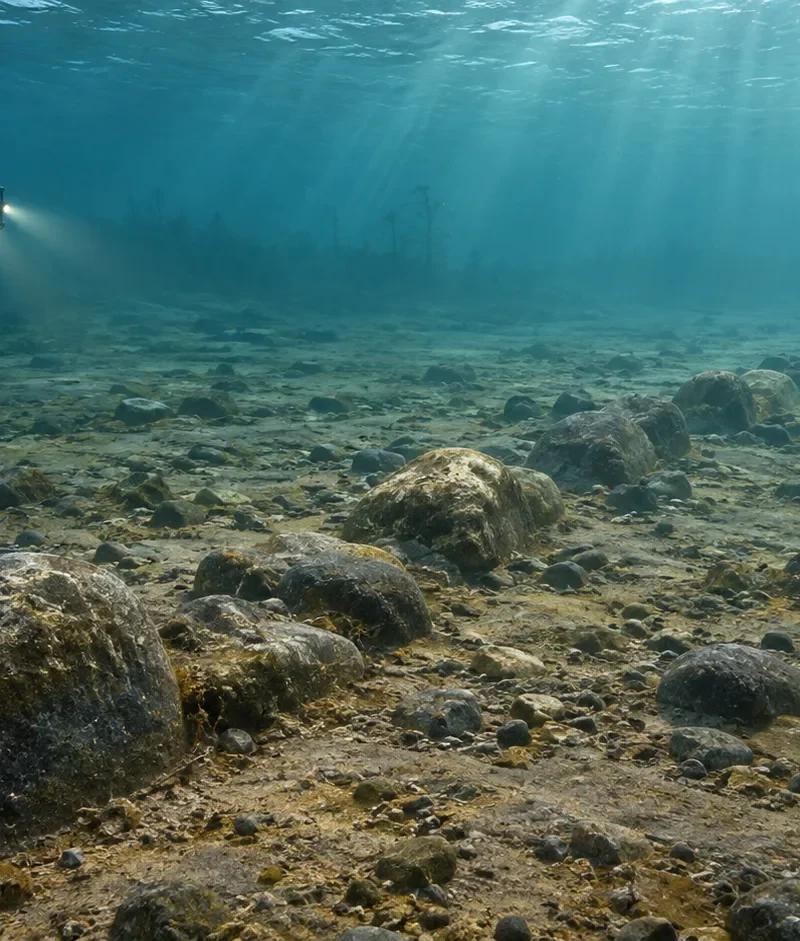 Interpretive underwater view of a stone alignment in Lake Michigan with an archaeological ROV