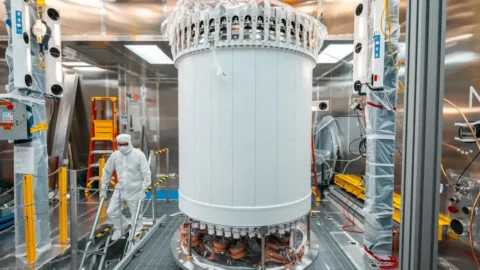 Researcher working beside the LUX-ZEPLIN dark-matter detector underground