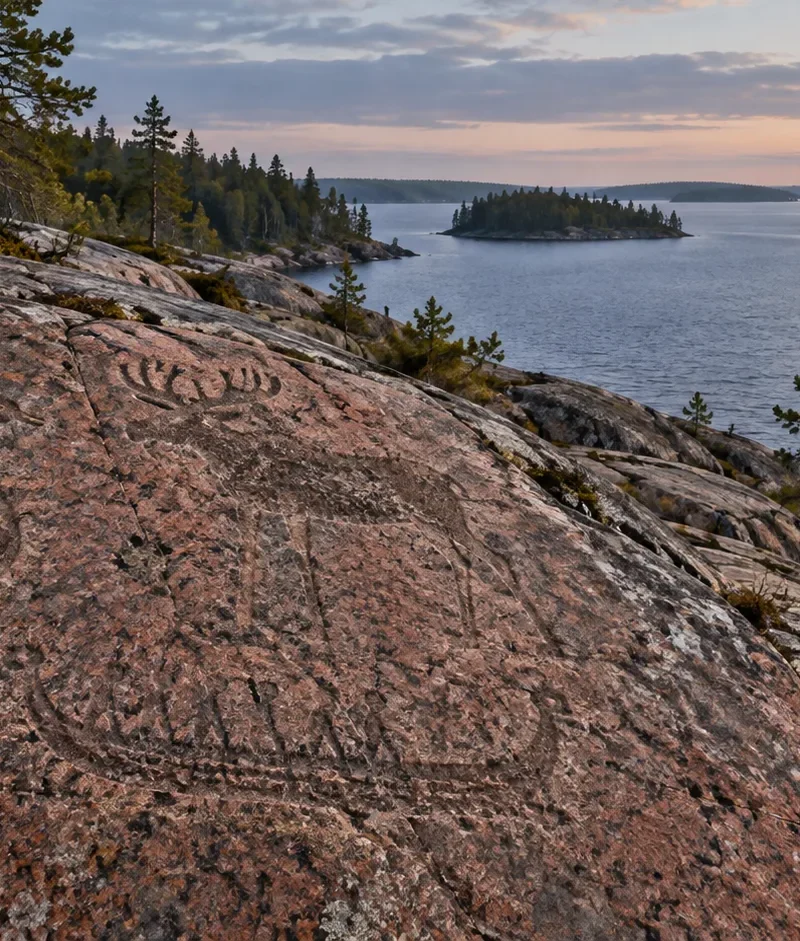 Interpretive illustration of Neolithic petroglyphs on a granite shore beside Lake Onega.