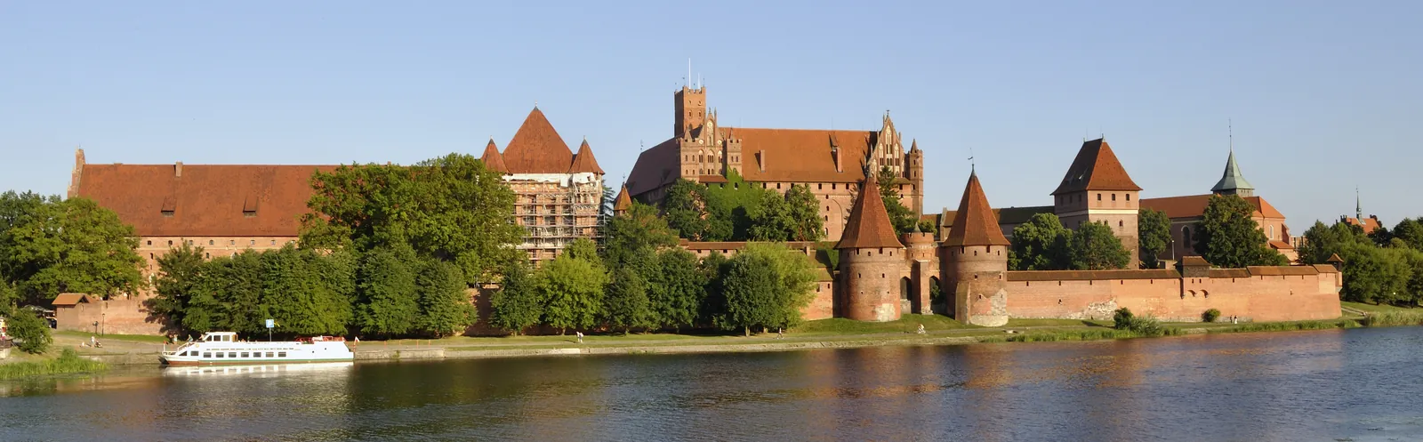 Panoramic view of Malbork Castle across the river