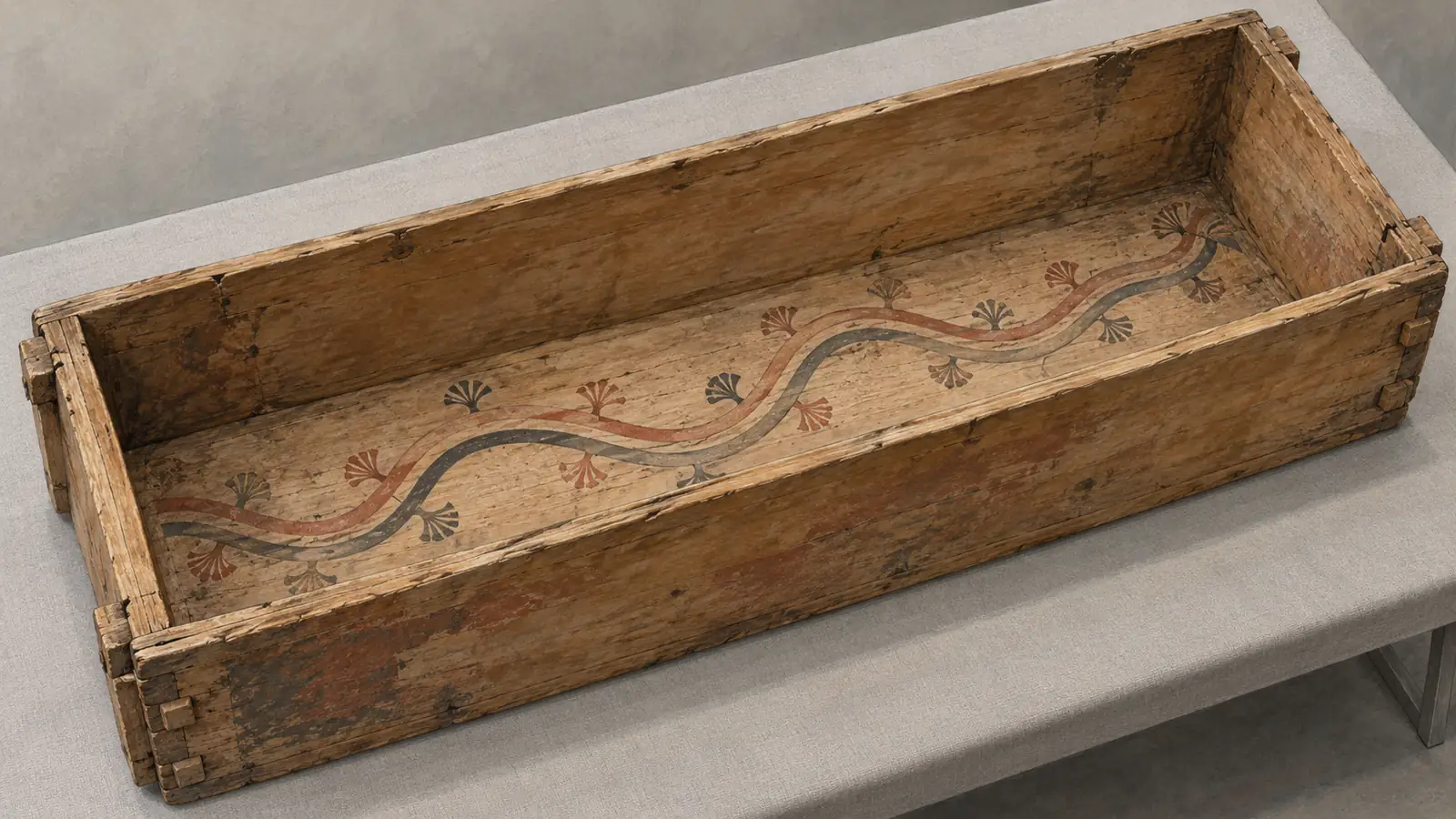 Conceptual illustration of two winding routes painted on the bottom of a rectangular wooden coffin.