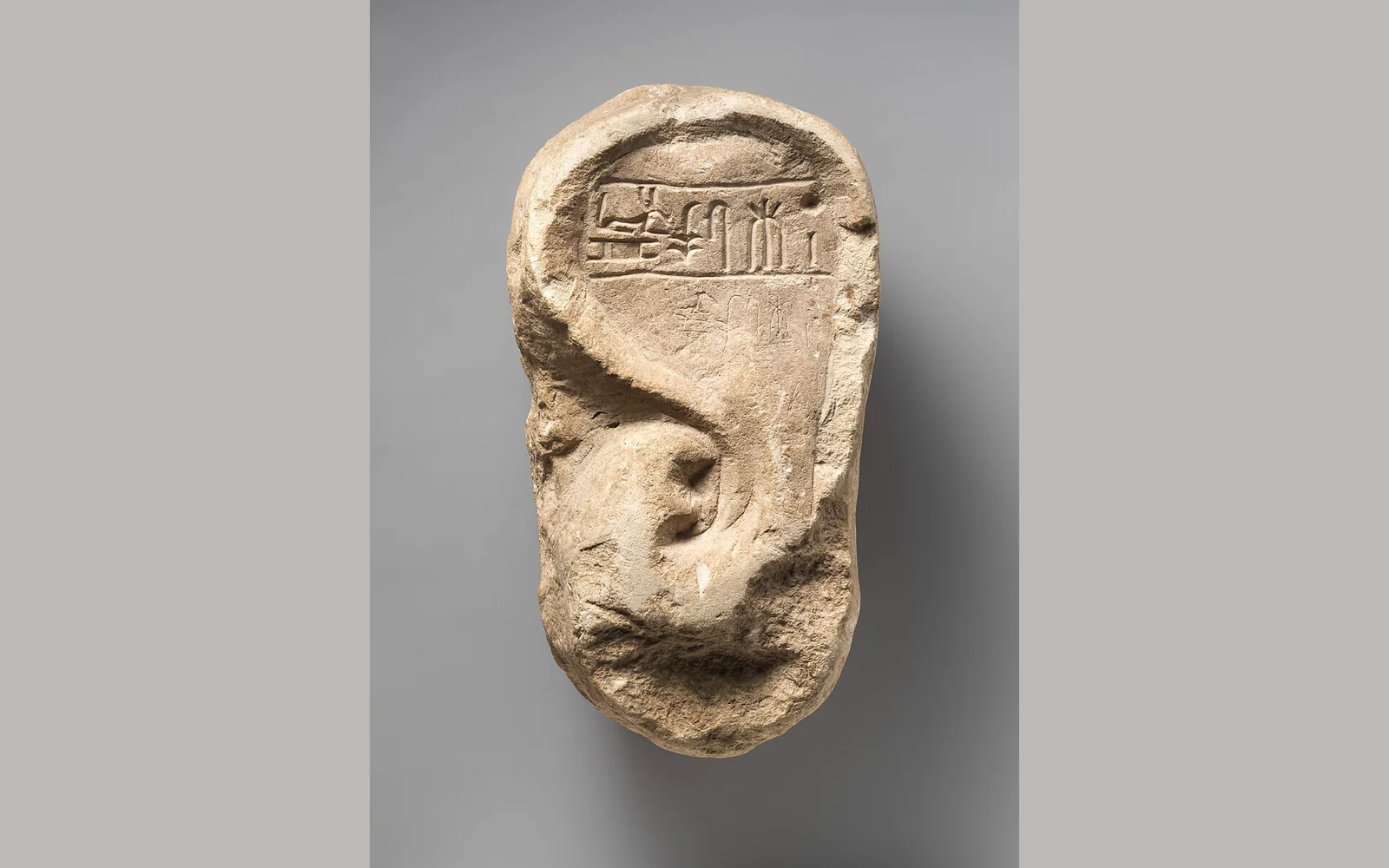Stone votive ear of Ramessumerysutekh, with a carved inscription above the ear.